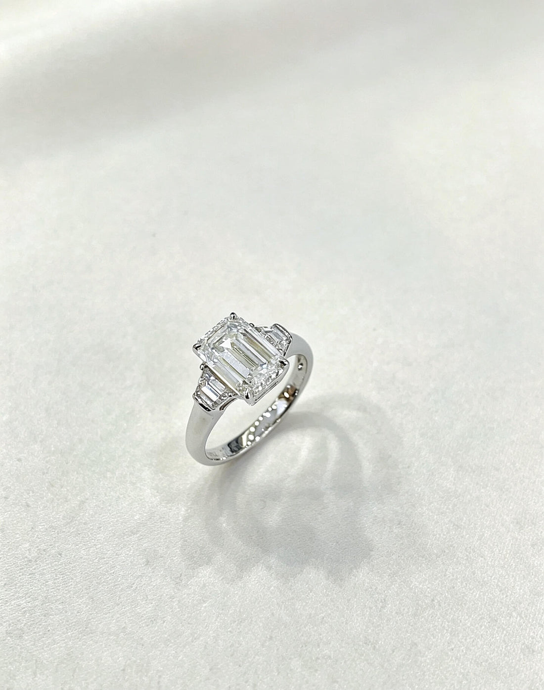 Emerald cut lab grown diamond three stones engagement ring