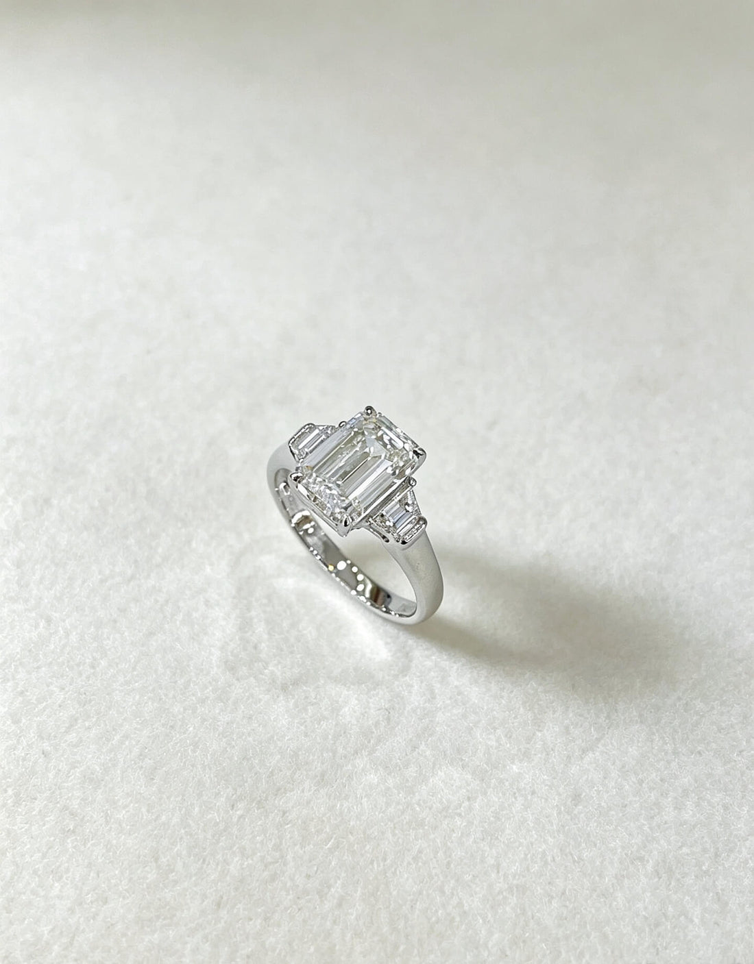 Emerald cut lab grown diamond three stones engagement ring