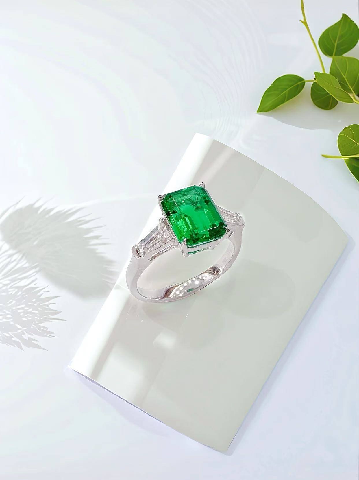 Emerald cut lab grown emerald three stones engagement ring