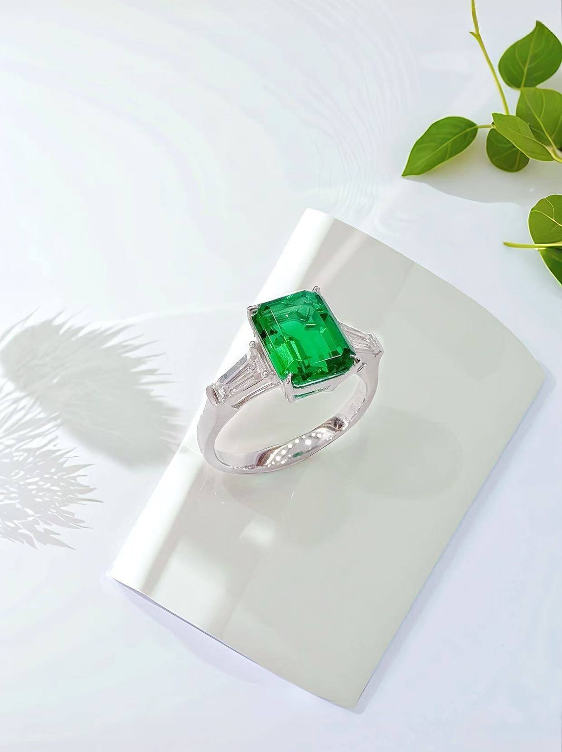 Emerald cut lab grown emerald three stones engagement ring