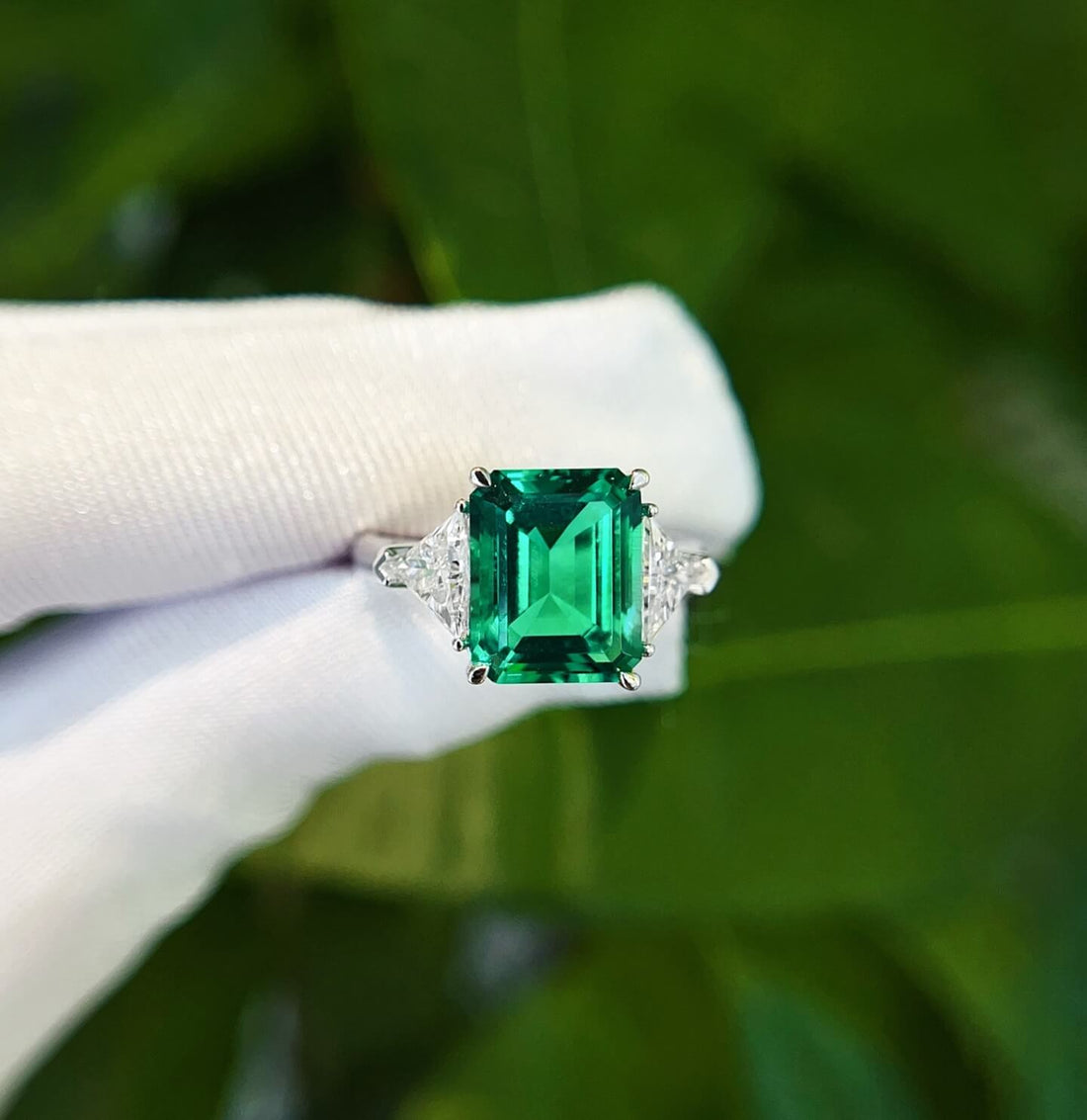 Emerald cut lab grown emerald three stones engagement ring