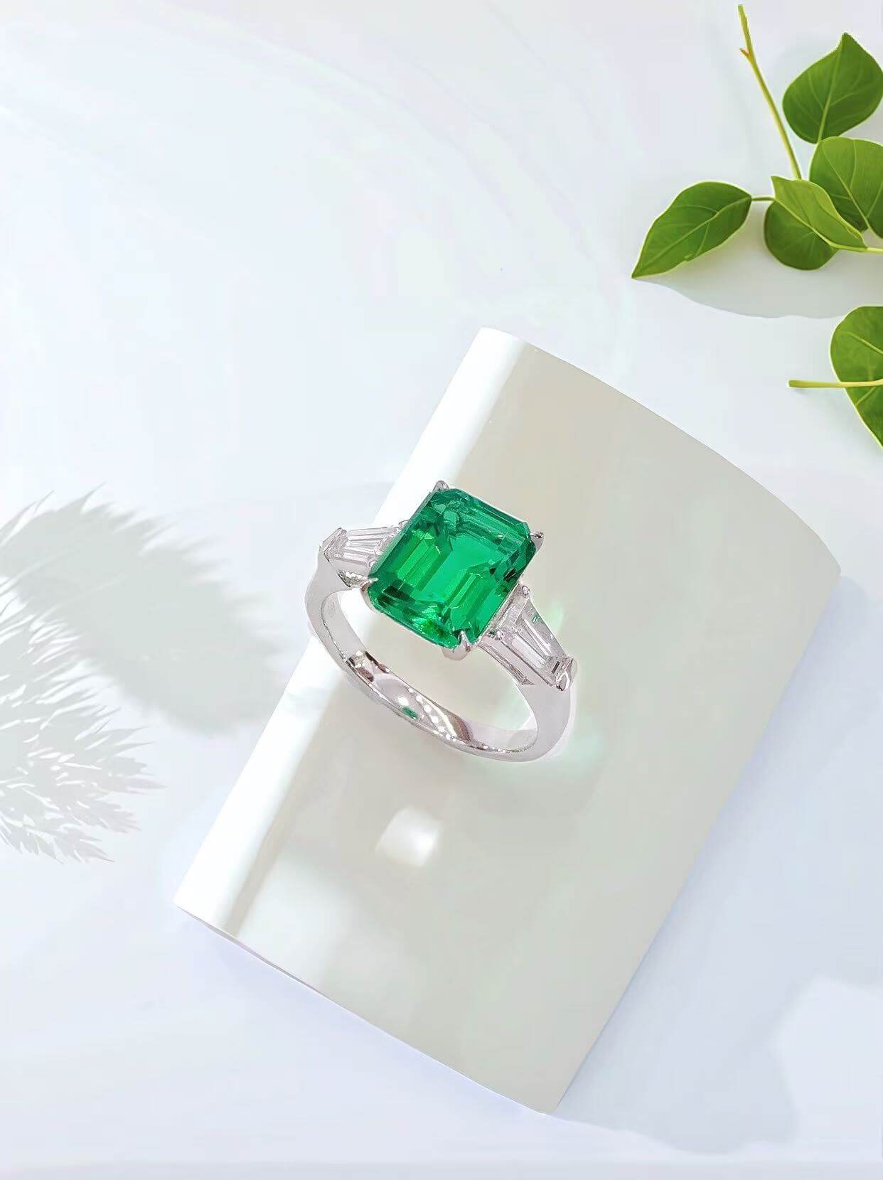 Emerald cut lab grown emerald three stones engagement ring
