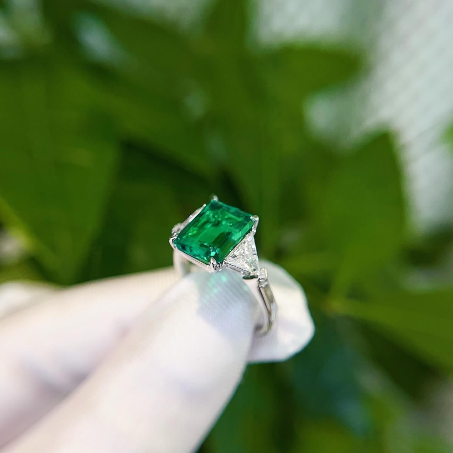 Emerald cut lab grown emerald three stones engagement ring