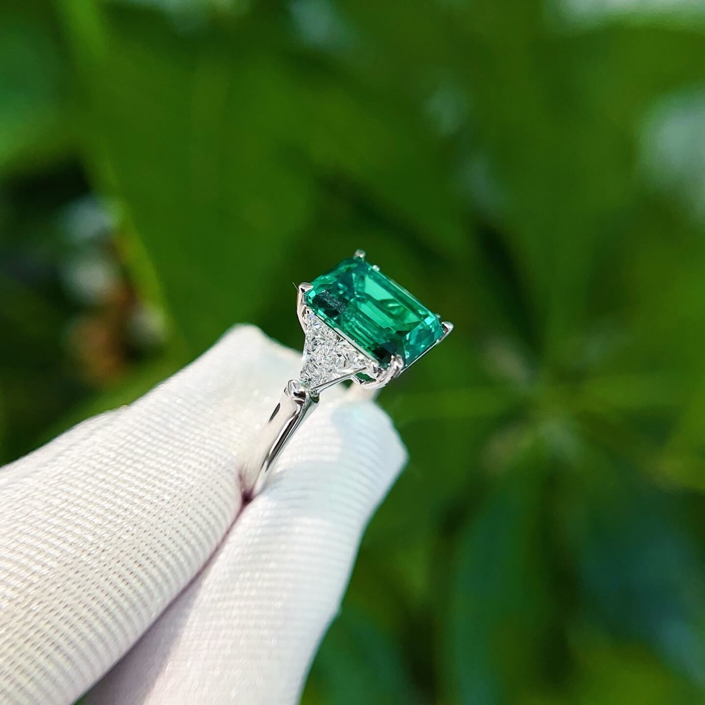 Emerald cut lab grown emerald three stones engagement ring