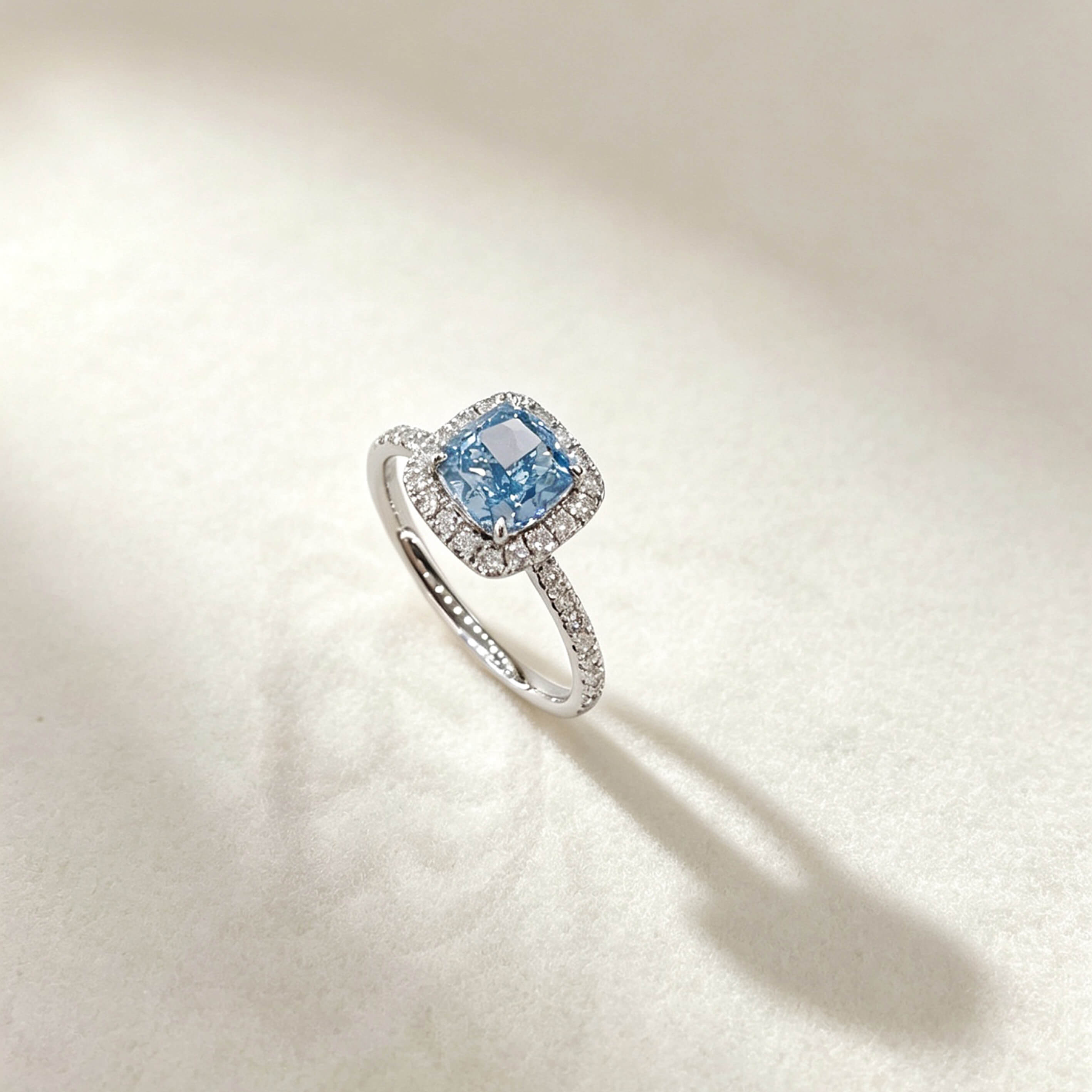 Halo setting cushion cut lab grown blue diamond engagement ring
