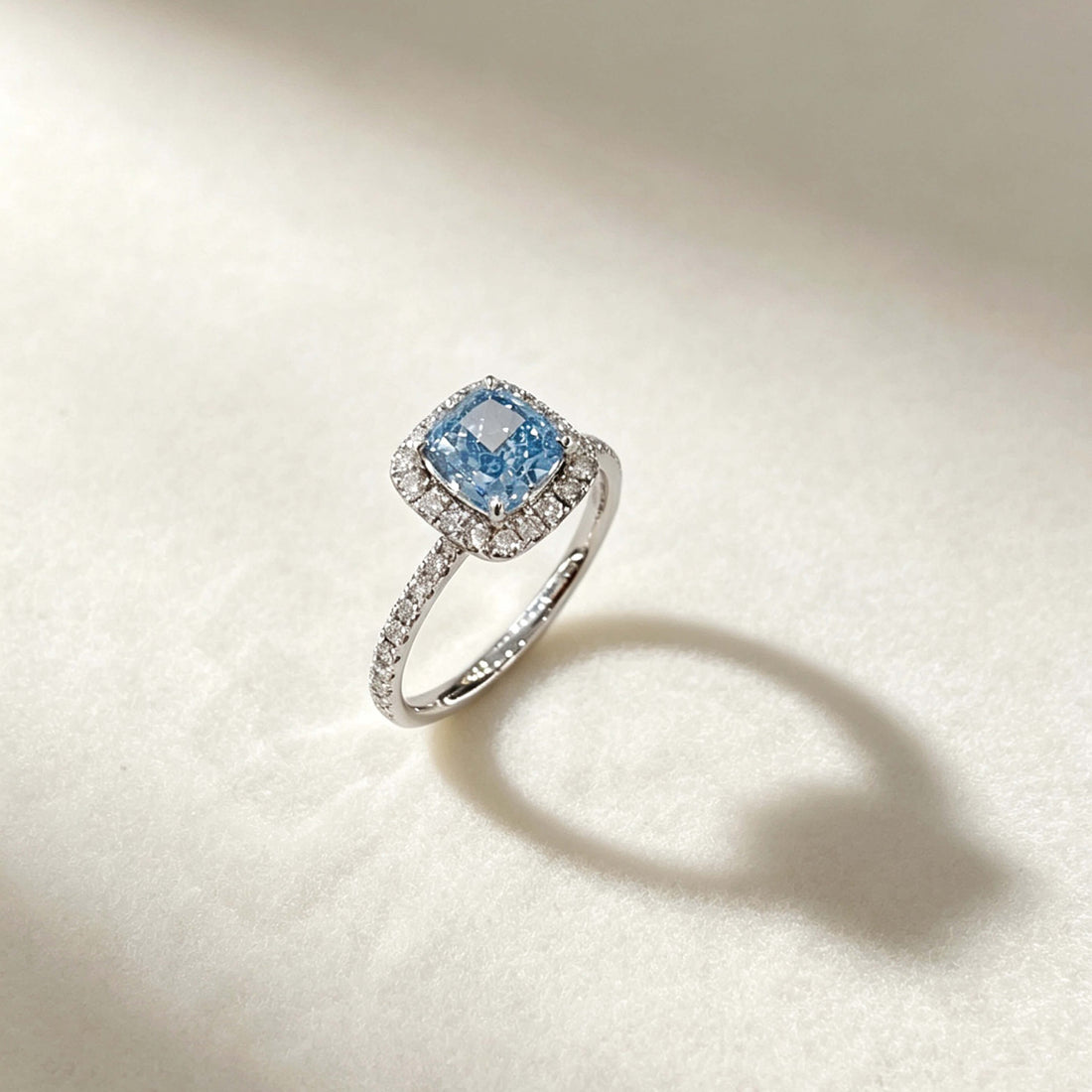 Halo setting cushion cut lab grown blue diamond engagement ring