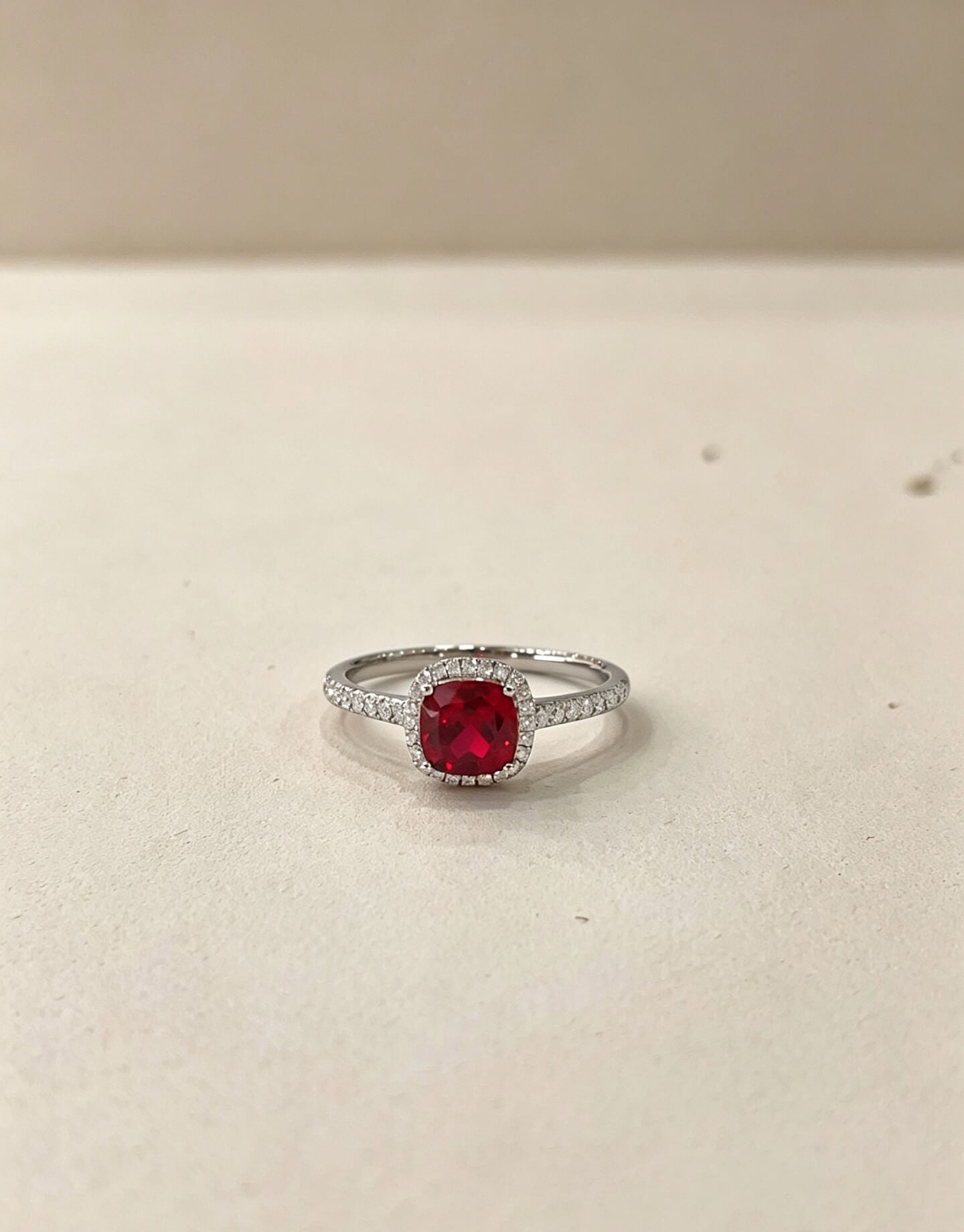 Halo setting cushion cut lab grown ruby engagement ring