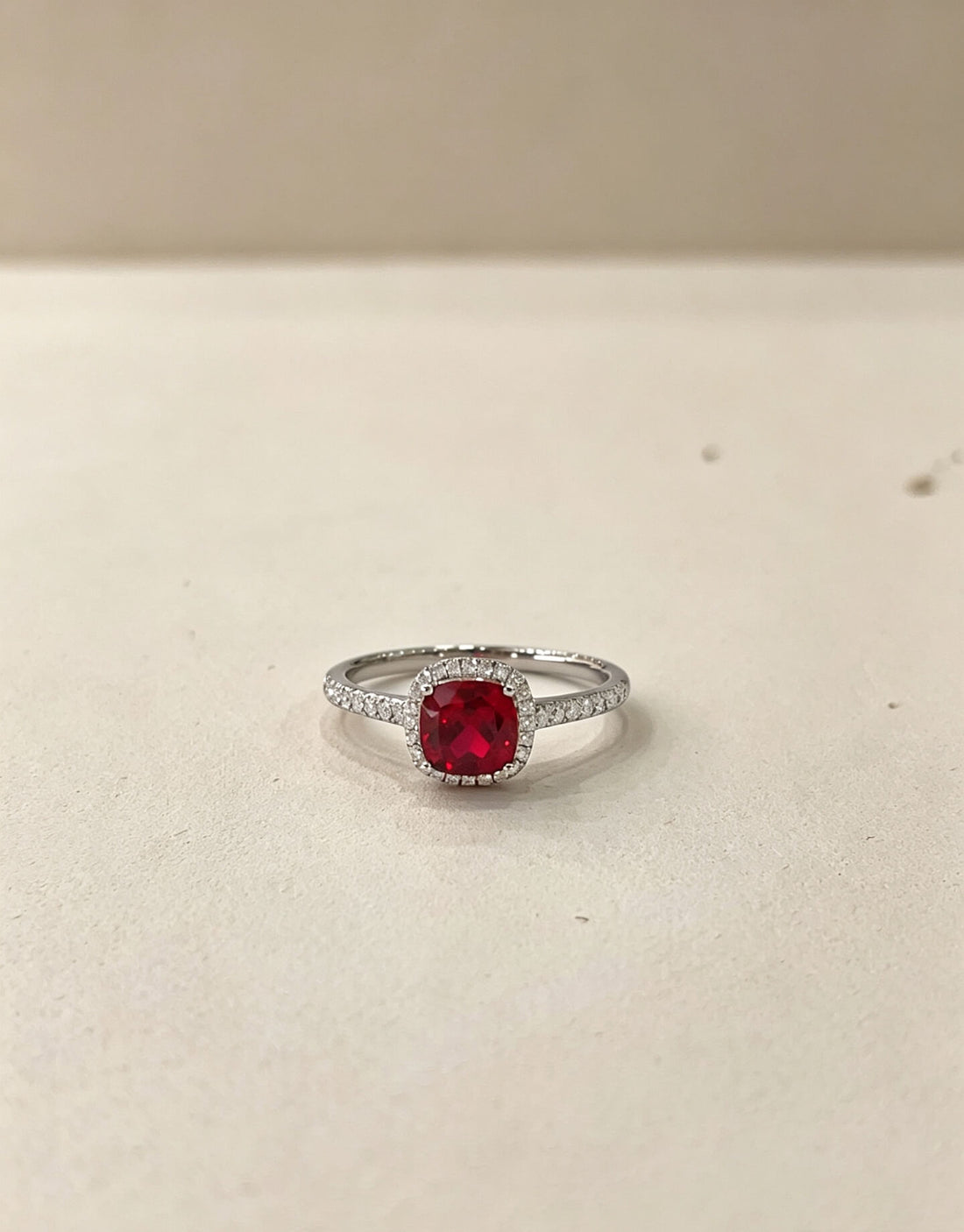 Halo setting cushion cut lab grown ruby engagement ring