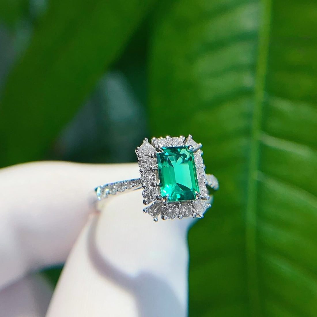 Halo setting lab grown emerald engagement ring