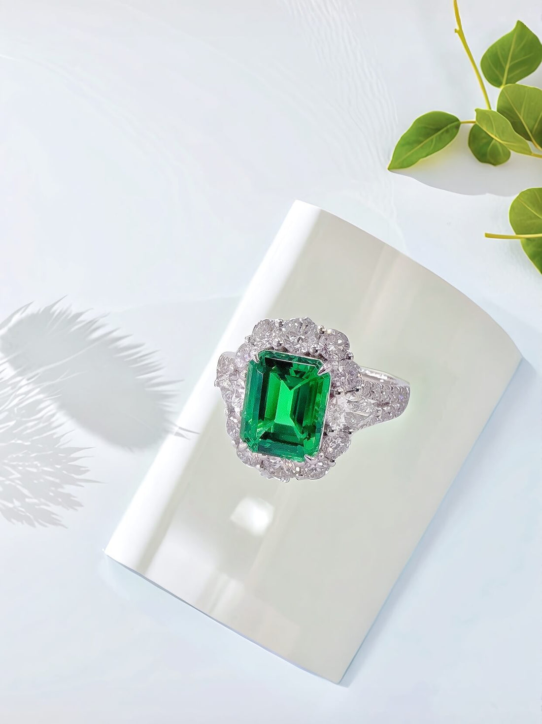 Halo setting lab grown emerald engagement ring