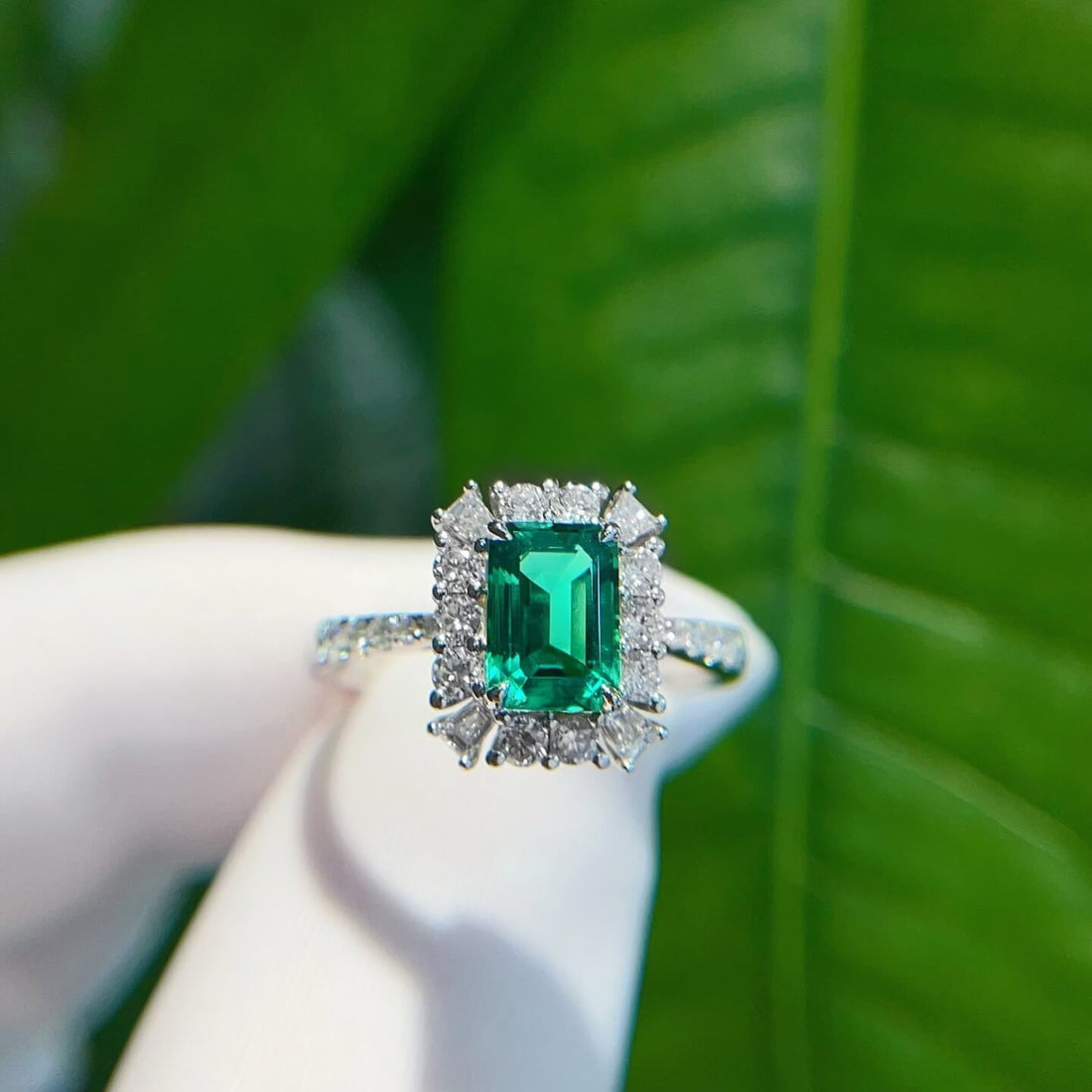 Halo setting lab grown emerald engagement ring