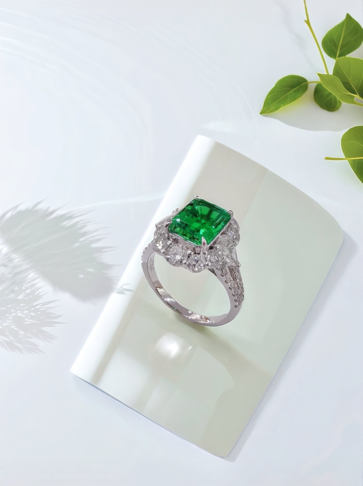Halo setting lab grown emerald engagement ring