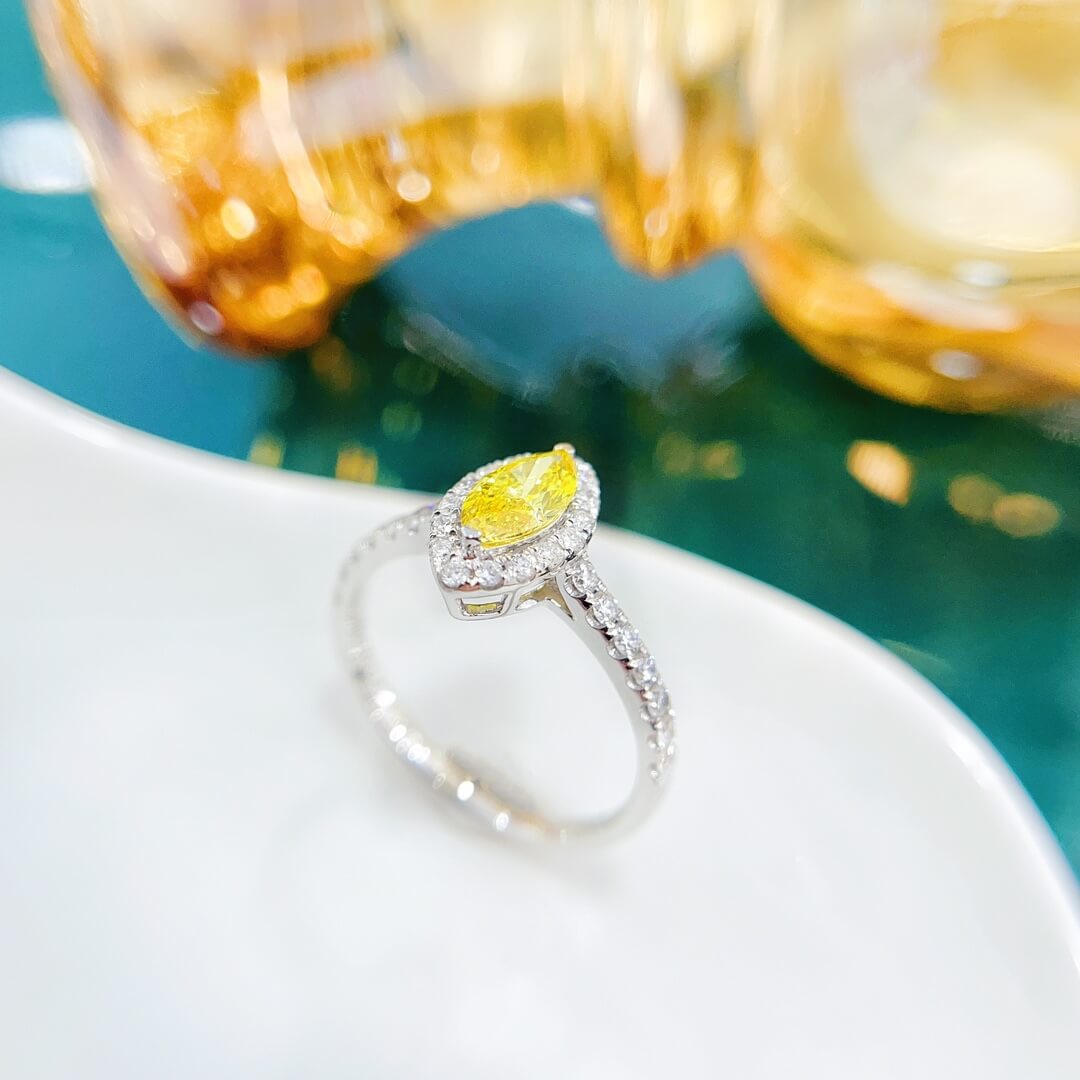 Halo setting marquise cut lab grown yellow diamond engagement ring