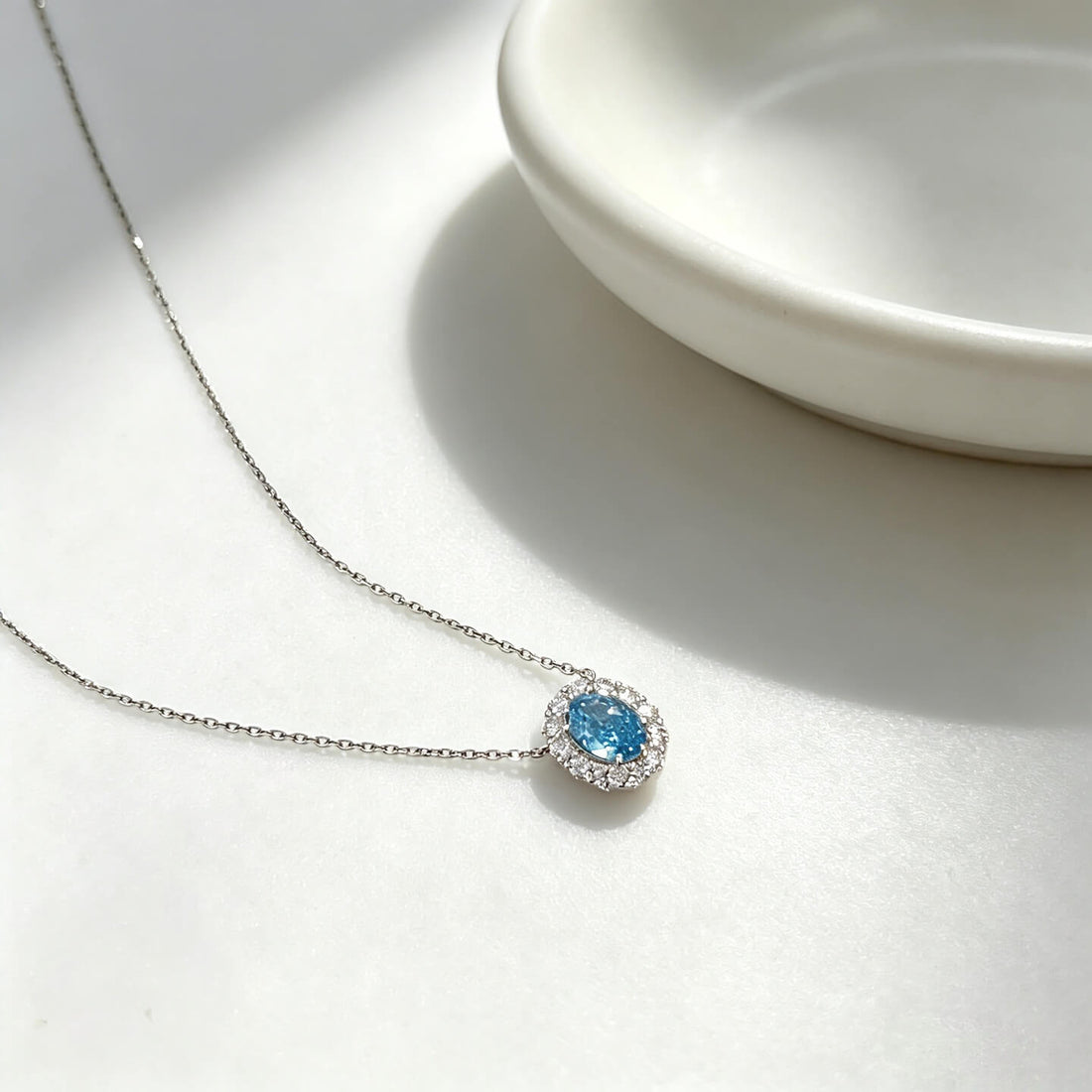 Halo setting oval cut lab grown blue diamond necklace