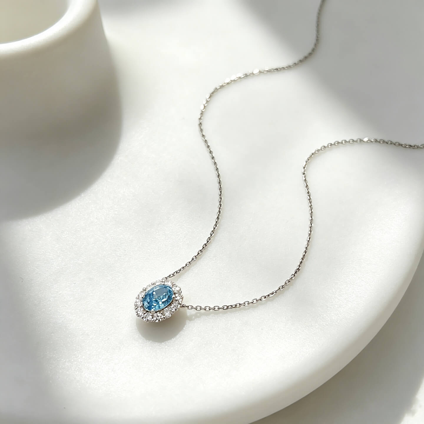 Halo setting oval cut lab grown blue diamond necklace