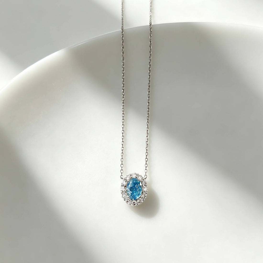 Halo setting oval cut lab grown blue diamond necklace