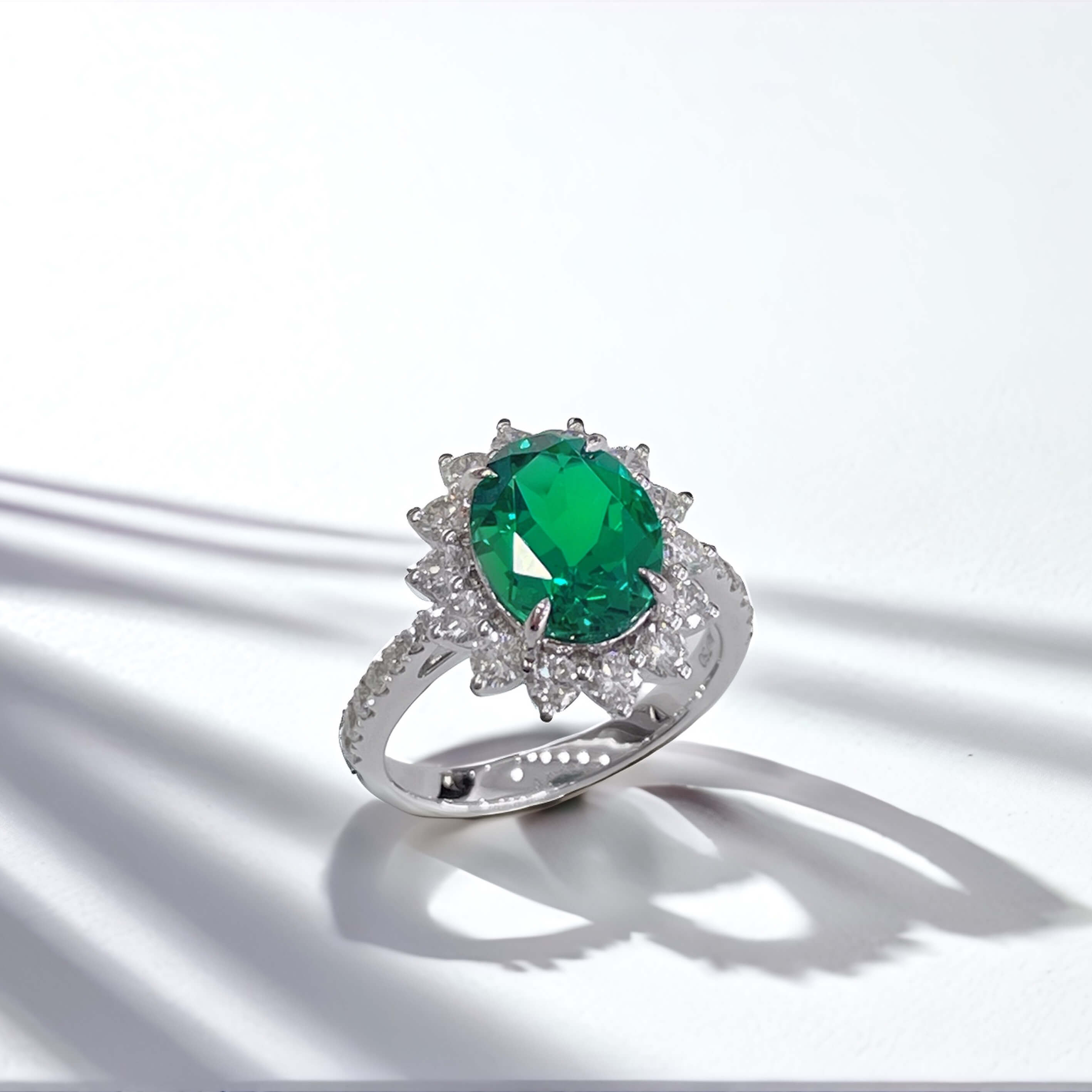 Halo setting oval cut lab grown emerald engagement ring