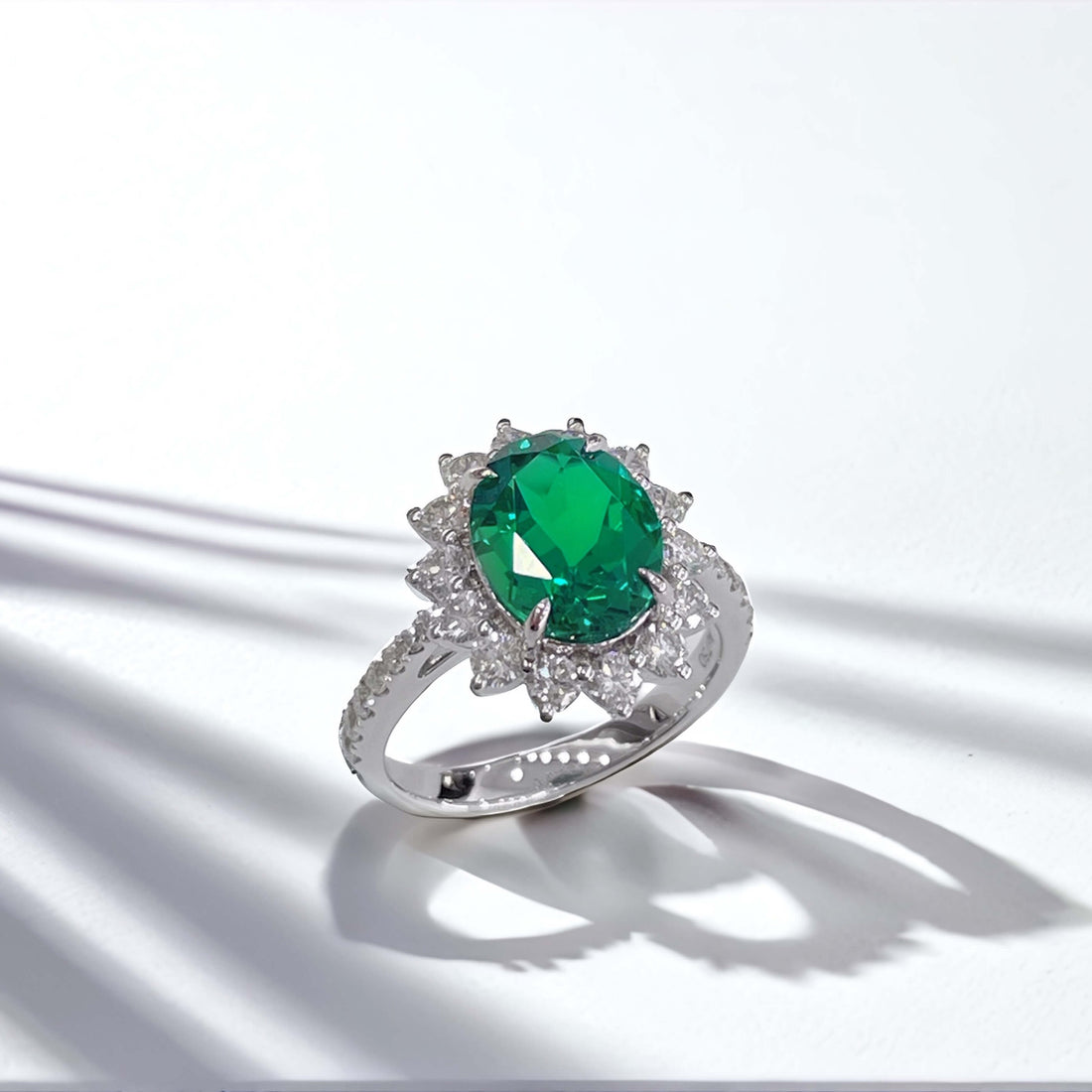 Halo setting oval cut lab grown emerald engagement ring