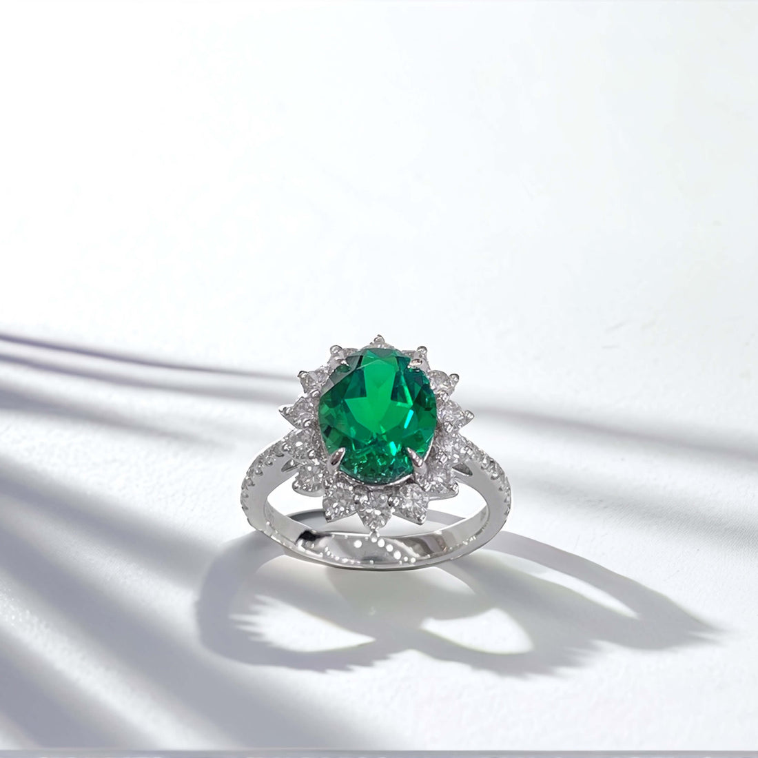 Halo setting oval cut lab grown emerald engagement ring