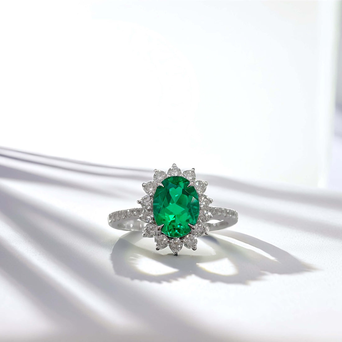 Halo setting oval cut lab grown emerald engagement ring