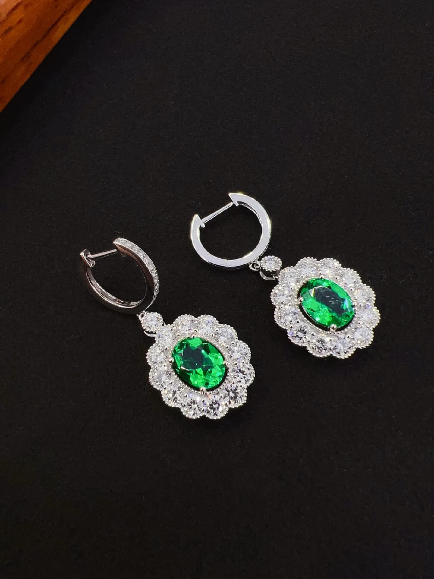 Halo setting oval cut lab grown emerald hoop earrings