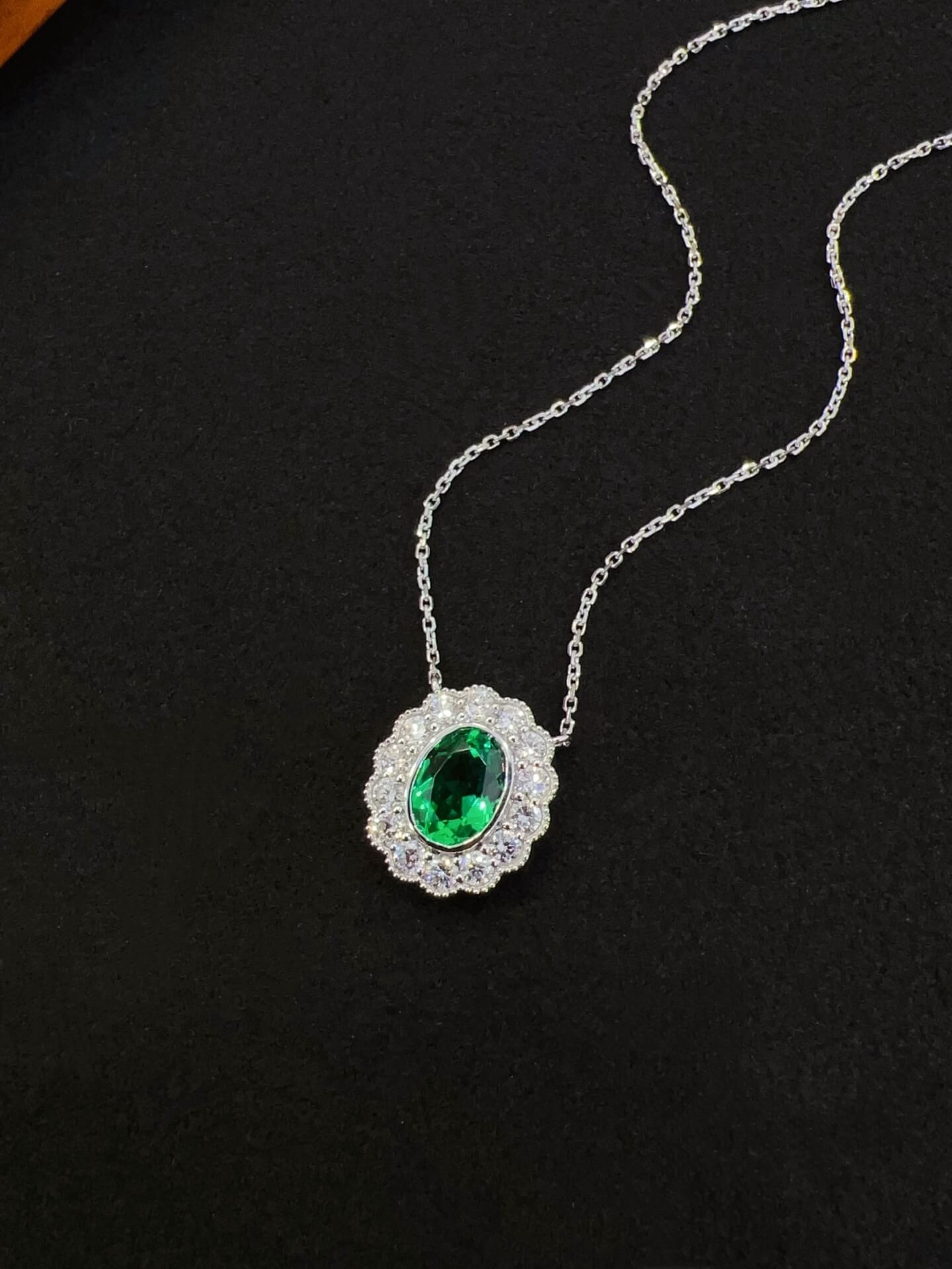 Halo setting oval cut lab grown emerald pendant necklace