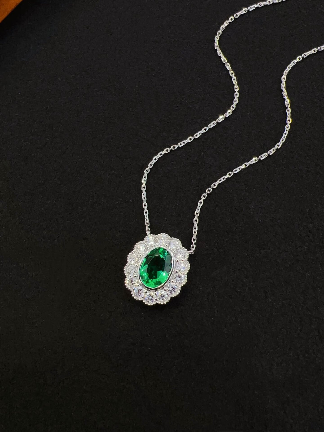 Halo setting oval cut lab grown emerald pendant necklace