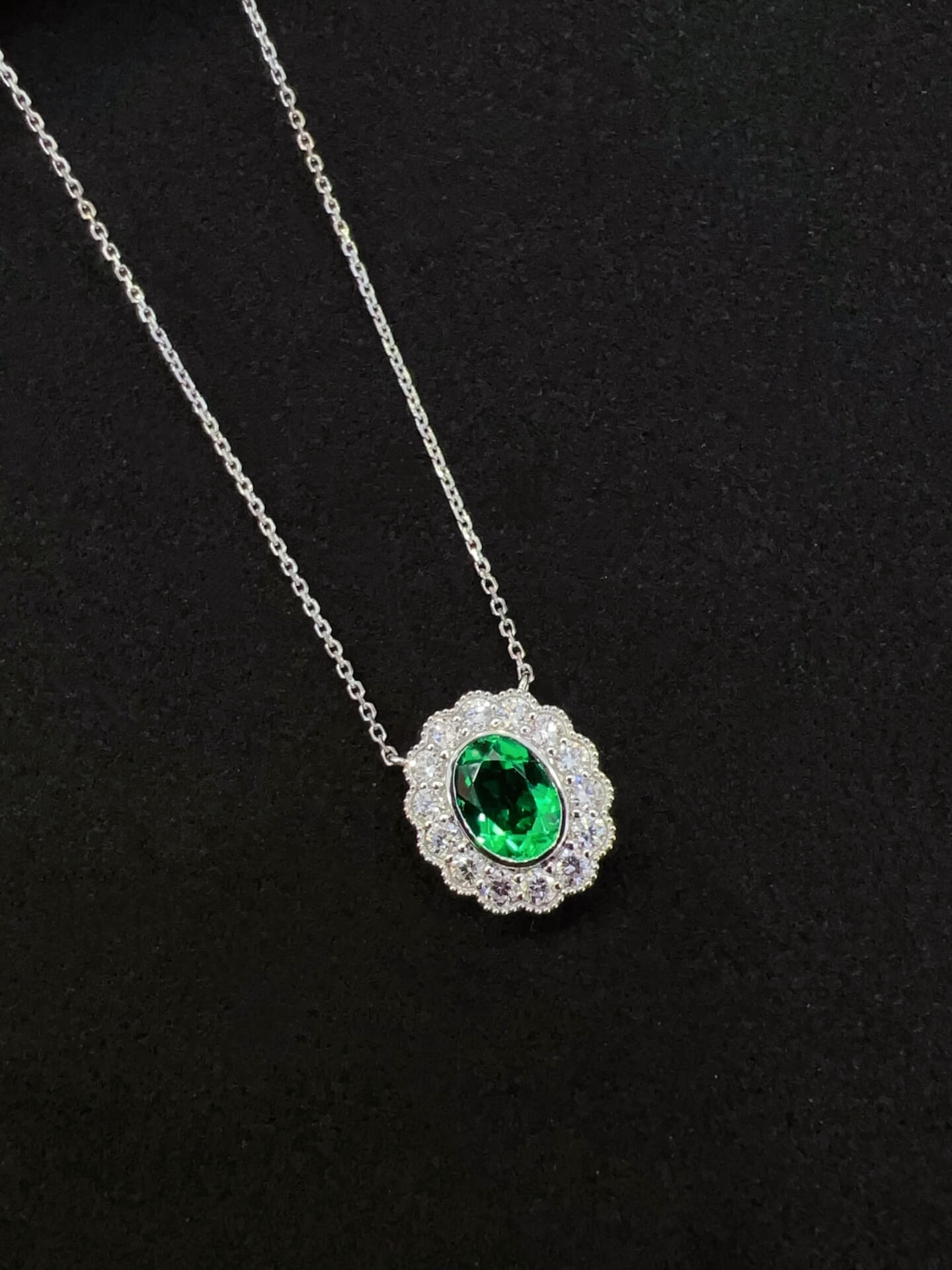 Halo setting oval cut lab grown emerald pendant necklace