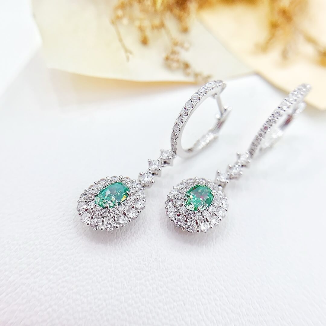 Halo setting oval cut lab grown green diamond hoop earrings