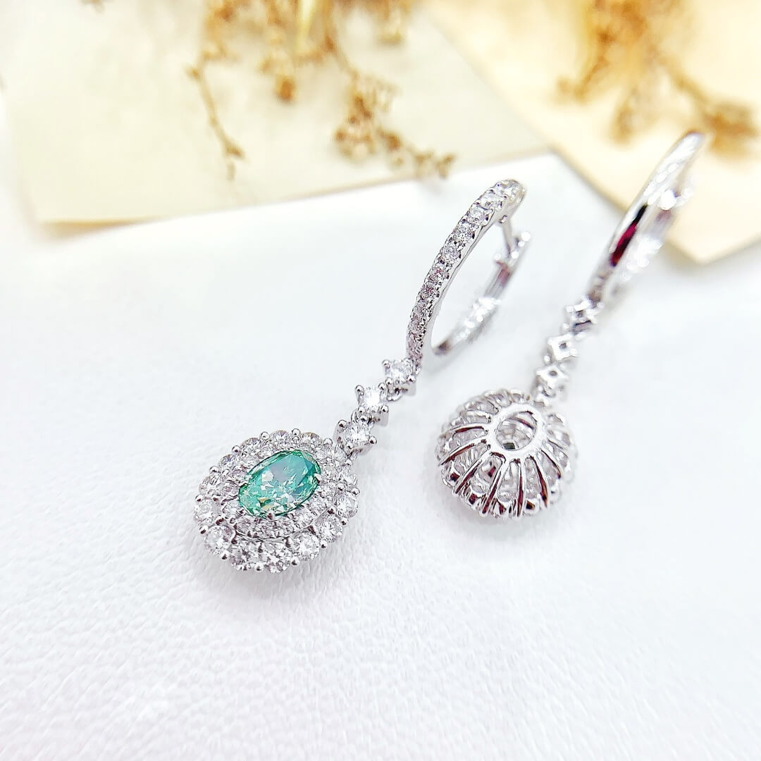 Halo setting oval cut lab grown green diamond hoop earrings