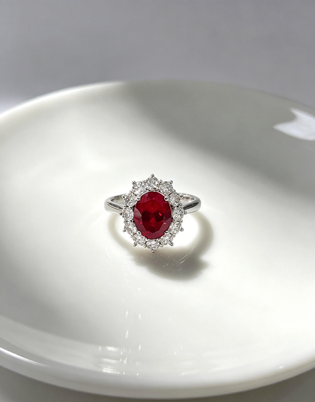 Halo setting oval cut lab grown ruby engagement ring
