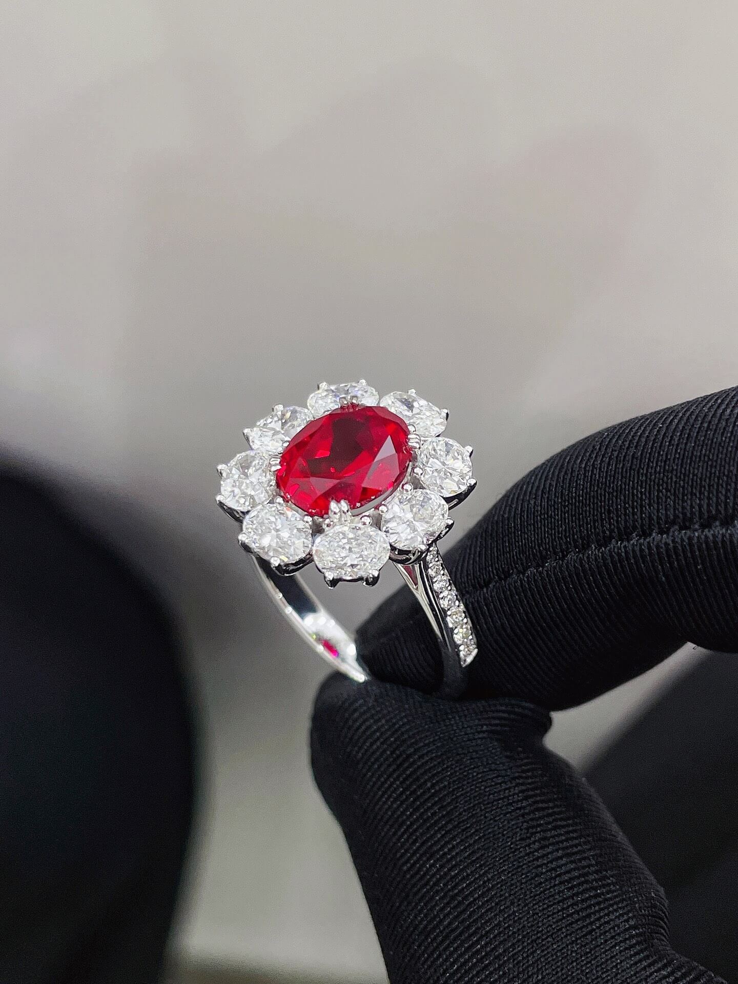 Halo setting oval cut lab grown ruby engagement ring