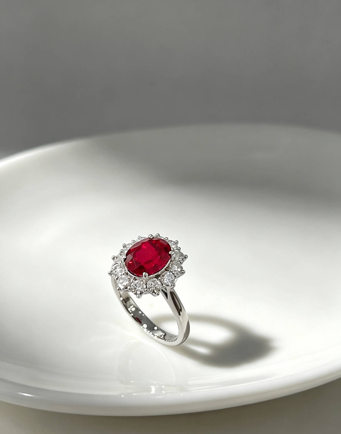 Halo setting oval cut lab grown ruby engagement ring