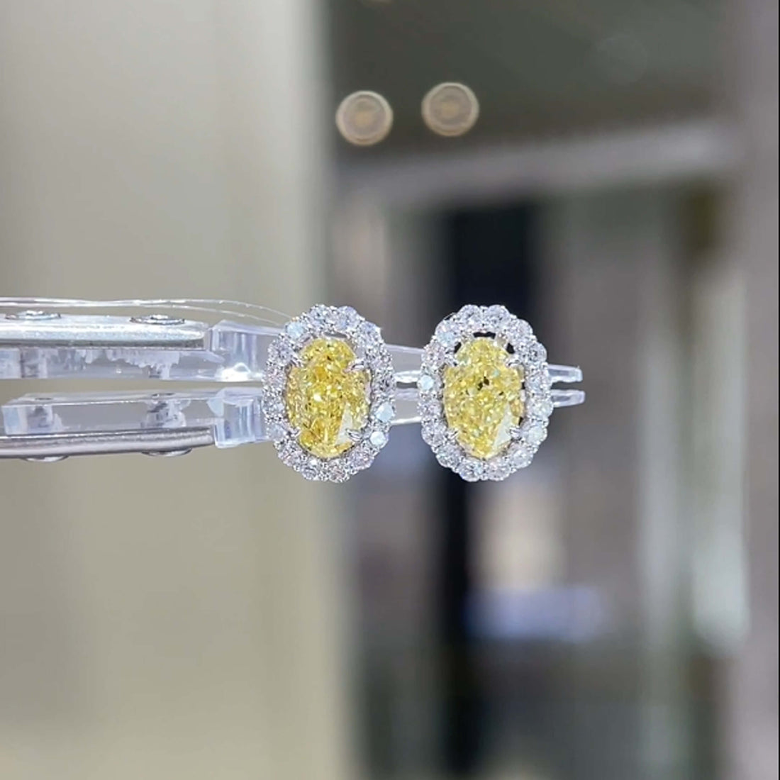 Halo setting oval cut lab grown yellow diamond earrings stud
