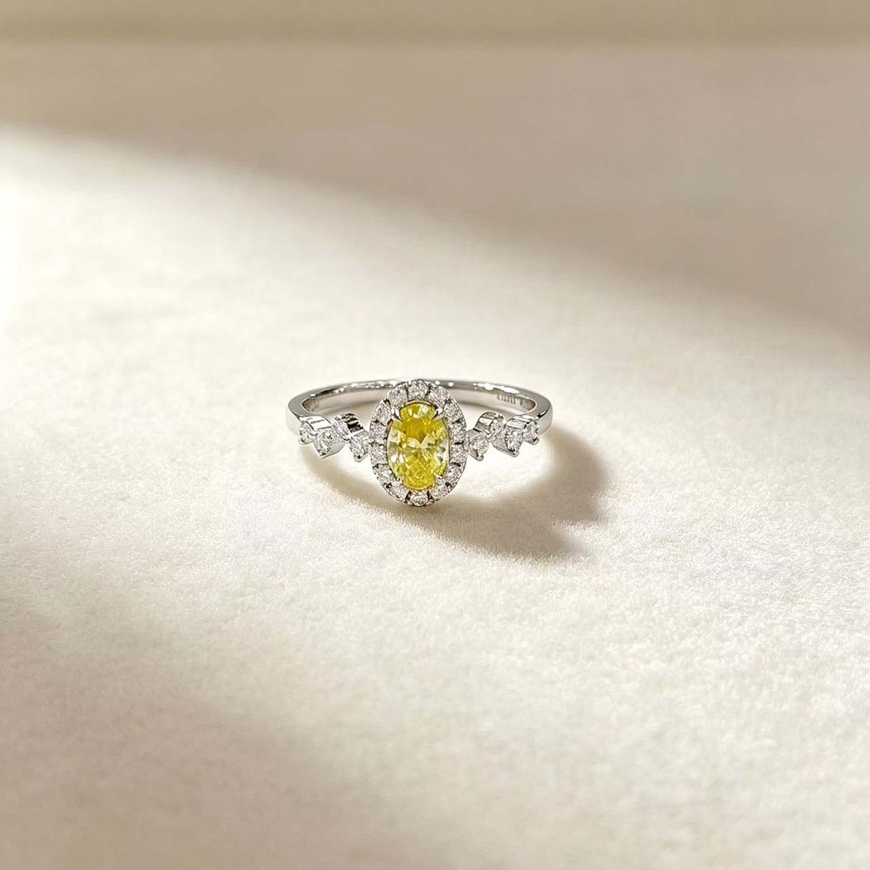 Halo setting oval cut lab grown yellow diamond engagement ring
