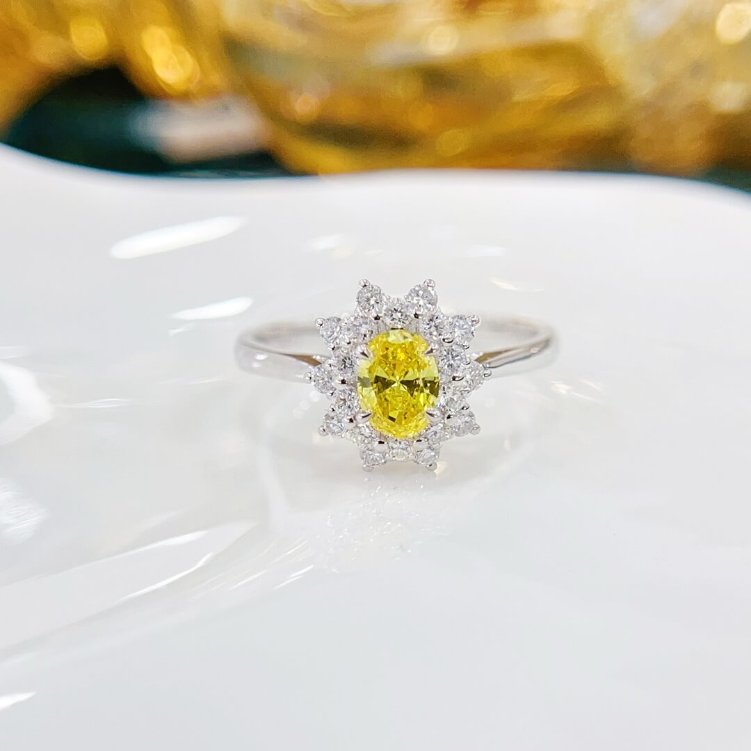Halo setting oval cut lab grown yellow diamond engagement ring