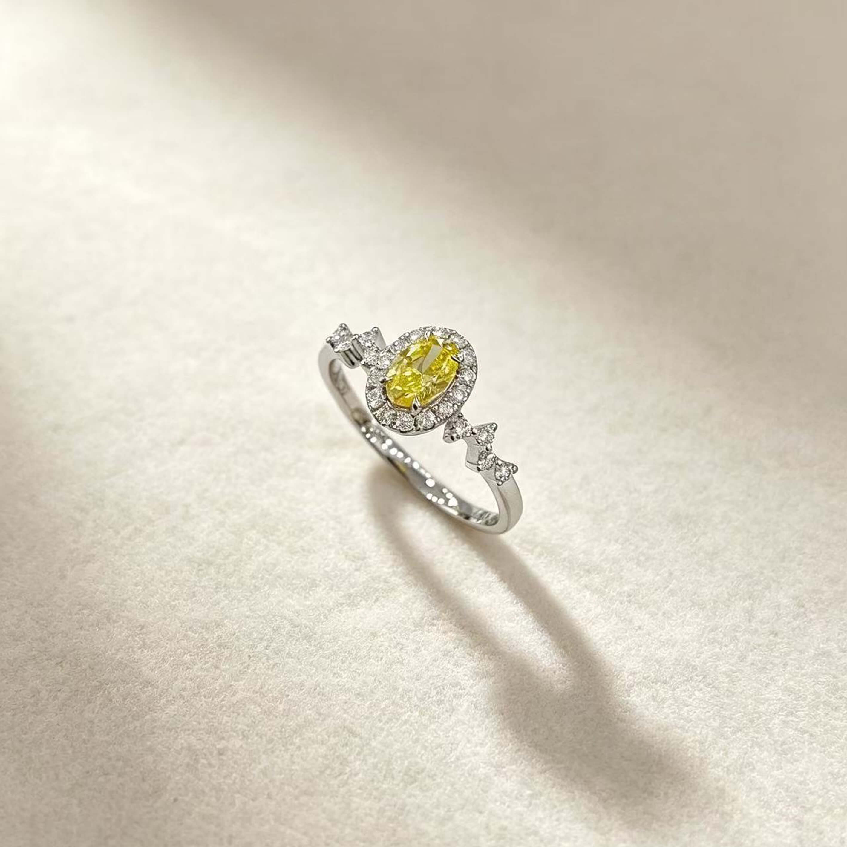 Halo setting oval cut lab grown yellow diamond engagement ring