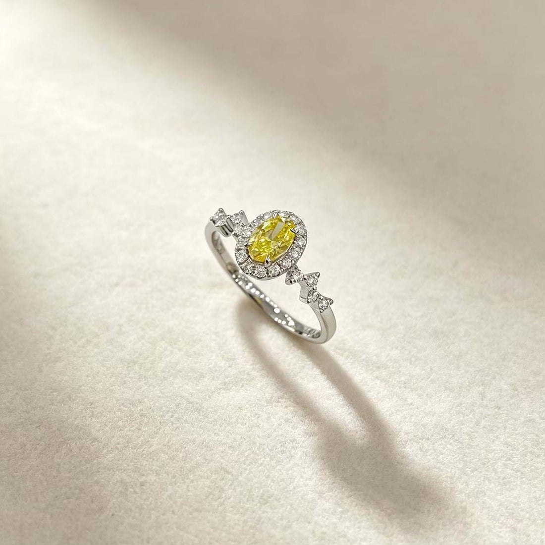 Halo setting oval cut lab grown yellow diamond engagement ring
