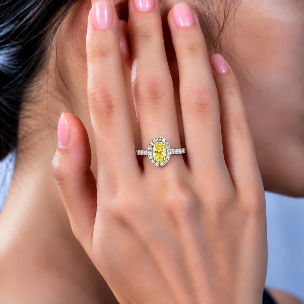 Halo setting oval cut lab grown yellow diamond engagement ring
