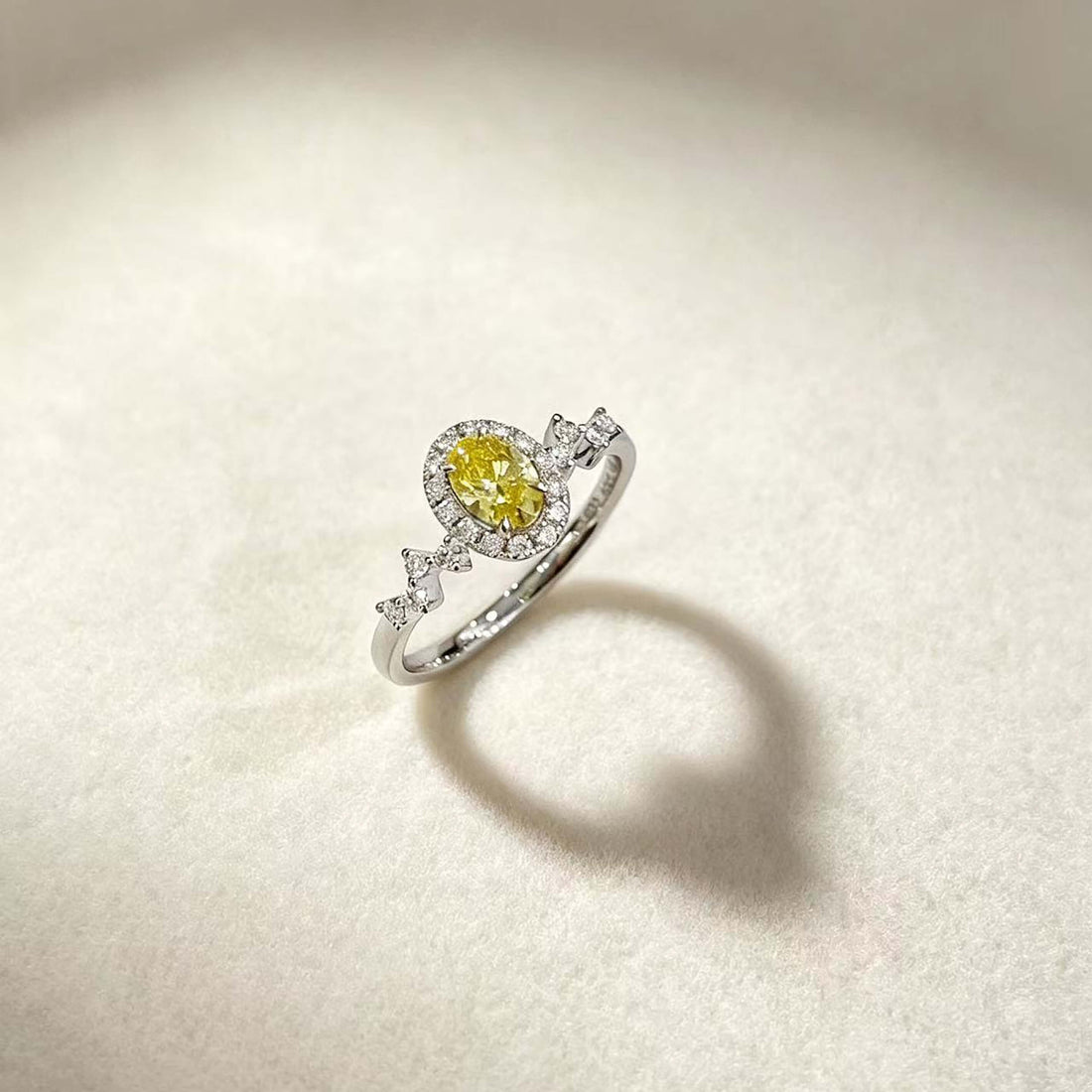 Halo setting oval cut lab grown yellow diamond engagement ring