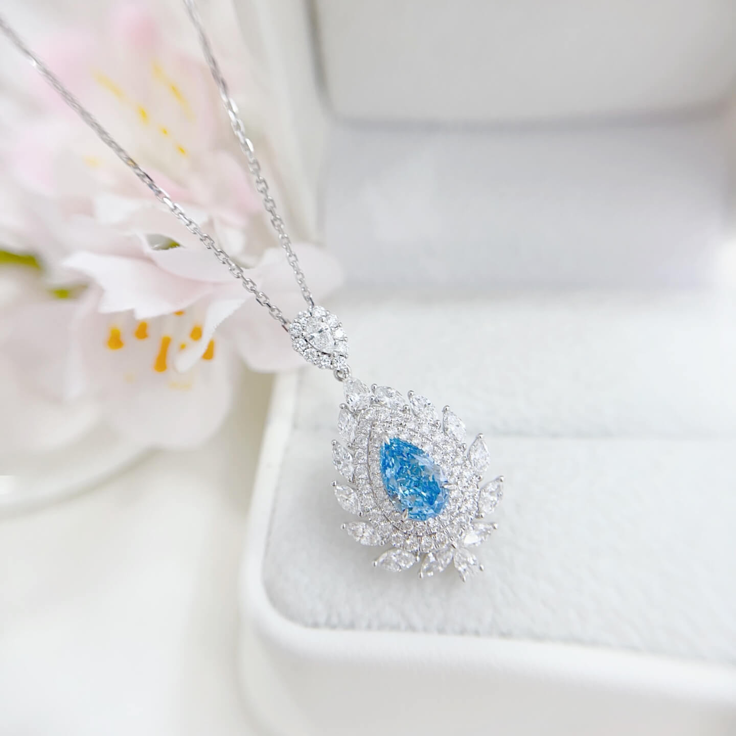 Halo setting pear cut lab grown blue diamond necklace