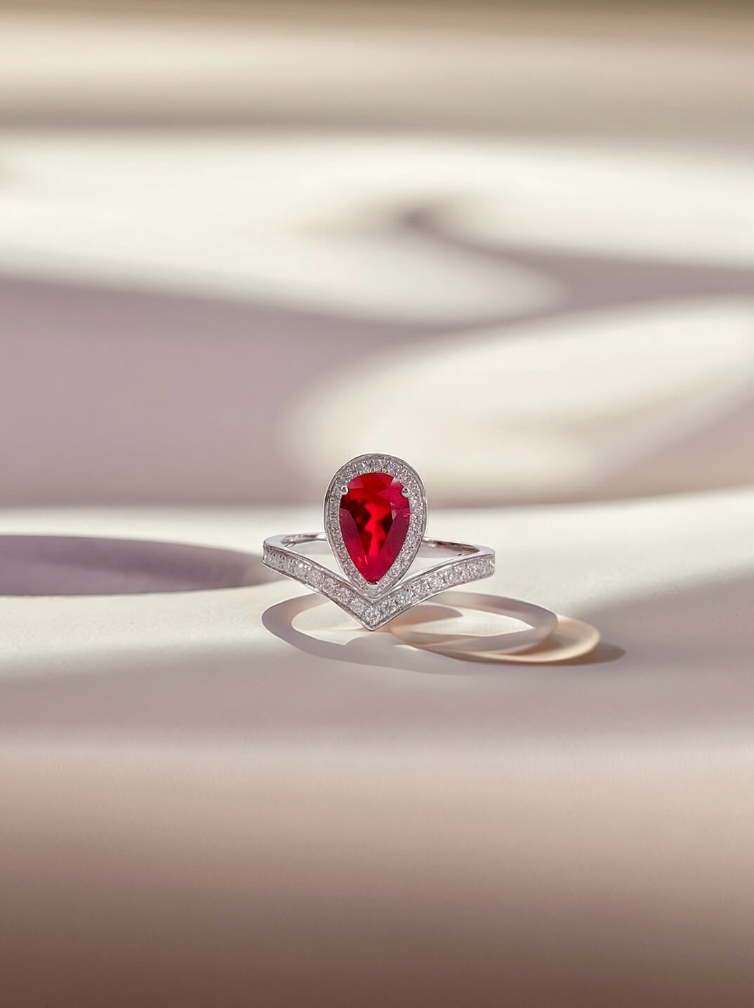 Halo setting pear cut lab grown ruby engagement ring