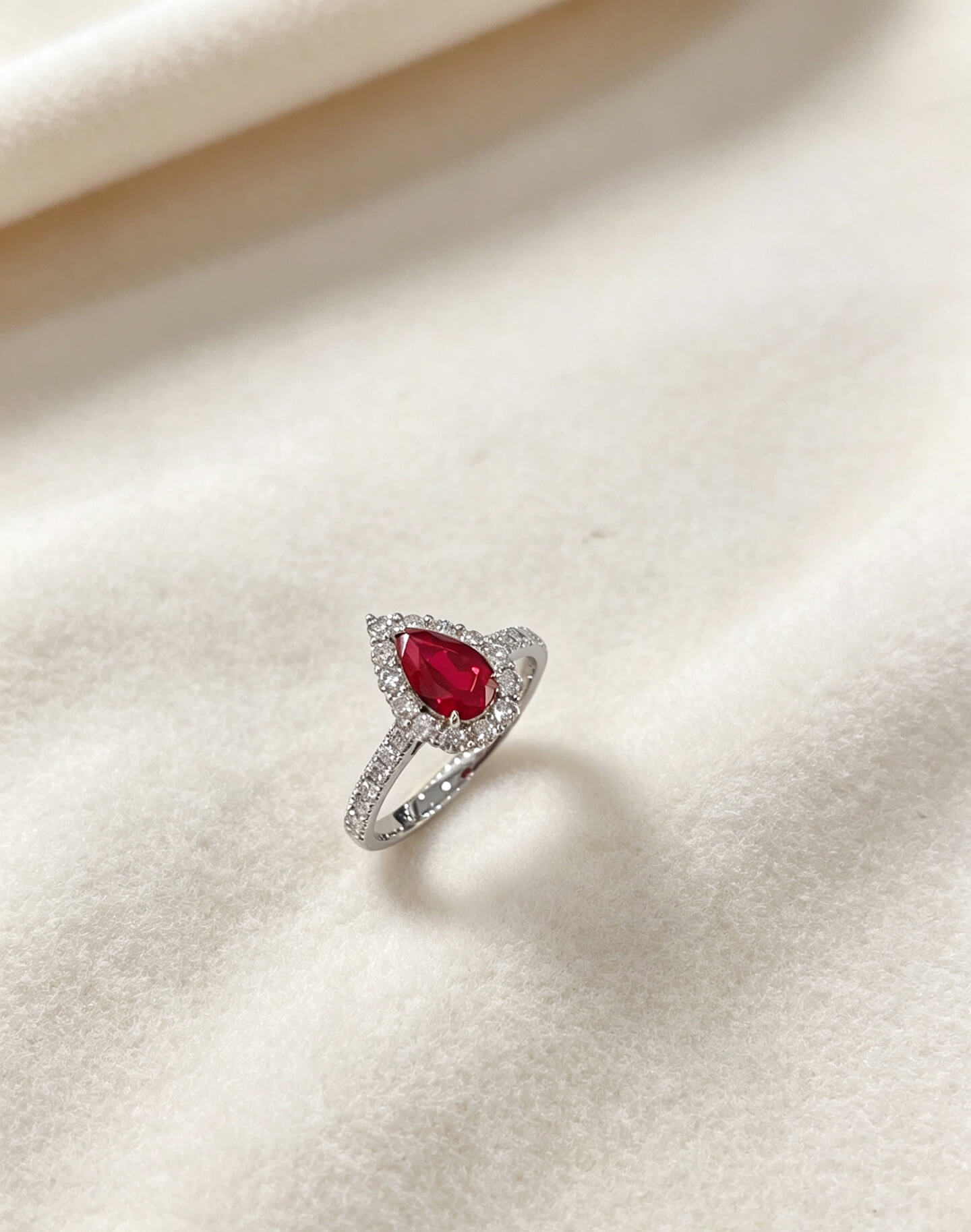 Halo setting pear cut lab grown ruby engagement ring