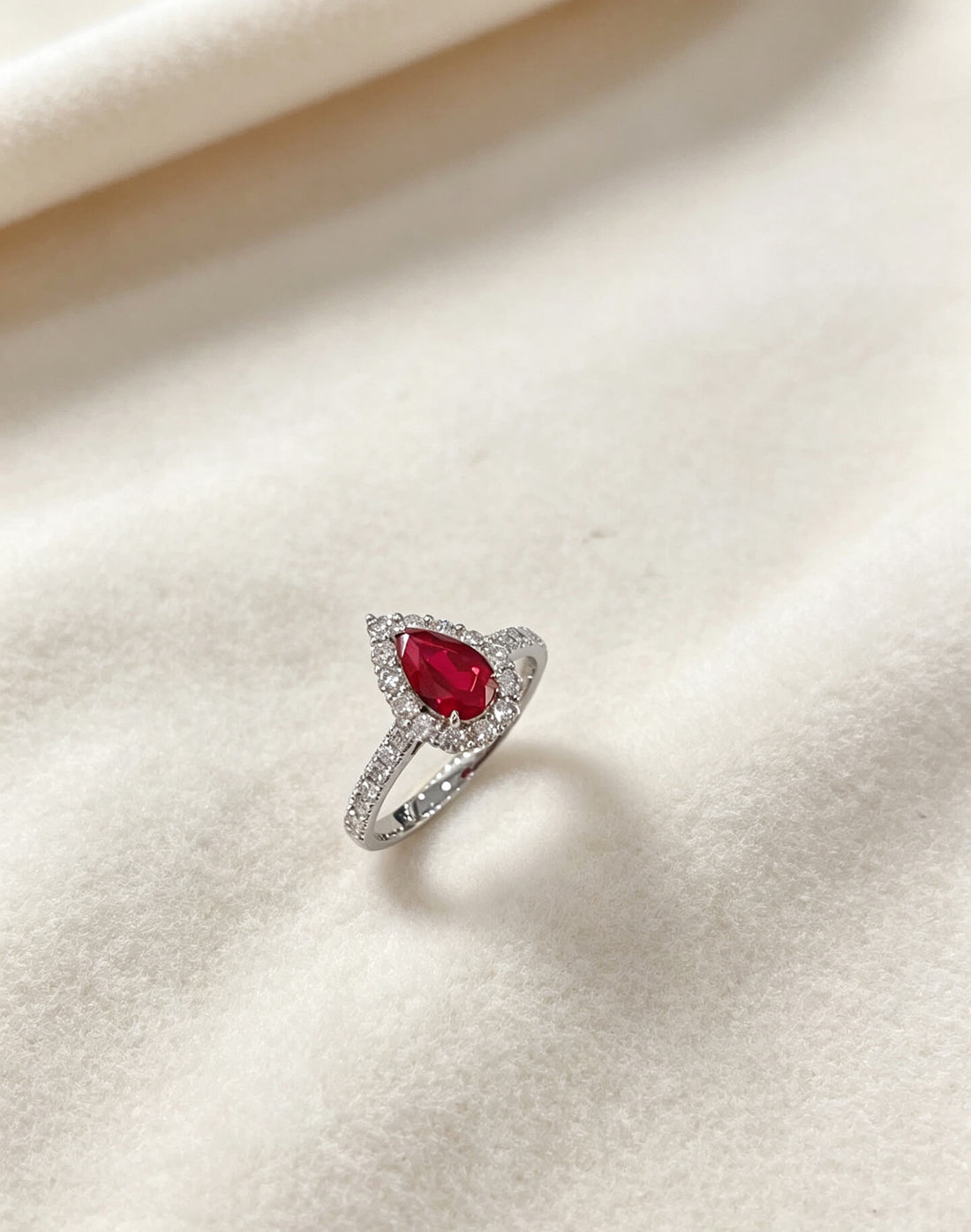 Halo setting pear cut lab grown ruby engagement ring