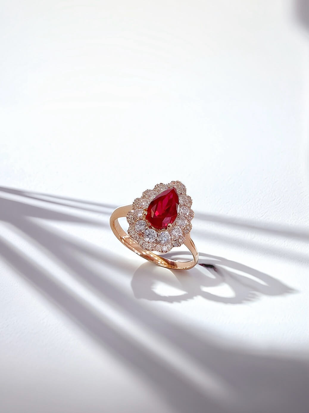 Halo setting pear cut lab grown ruby engagement ring