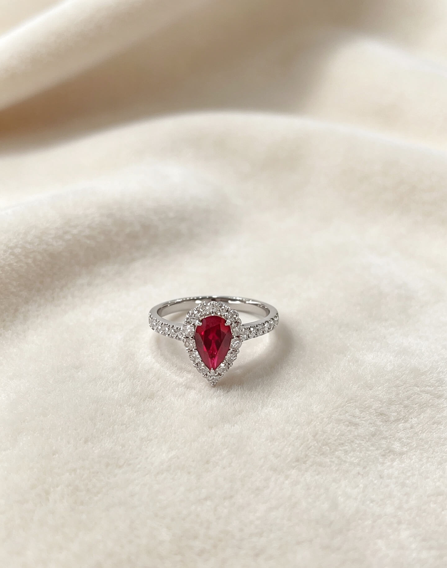 Halo setting pear cut lab grown ruby engagement ring