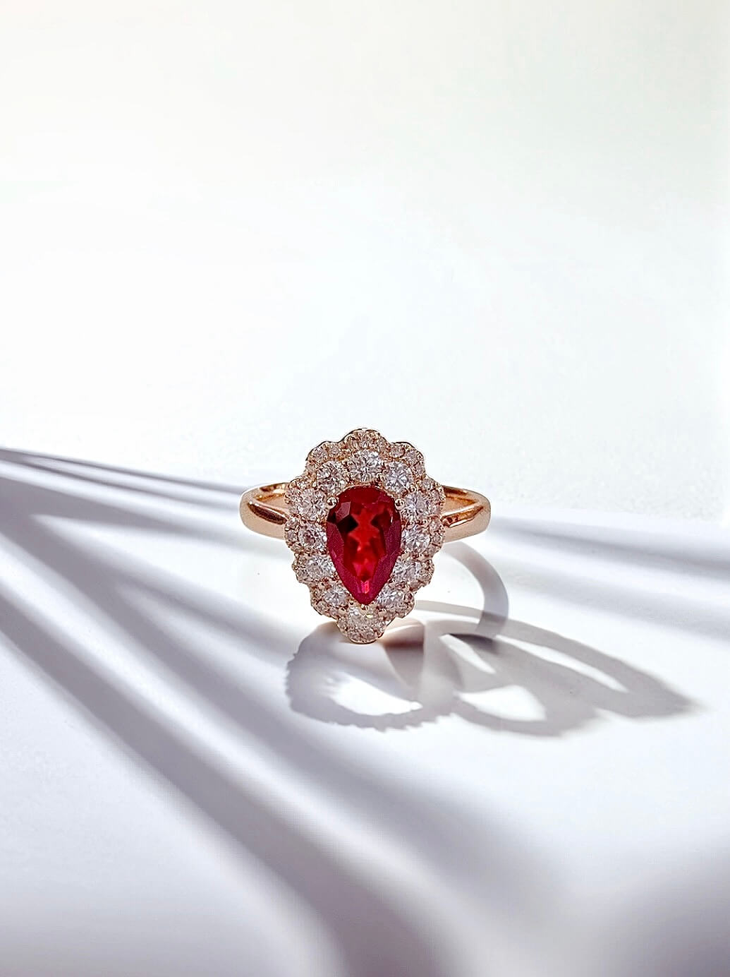 Halo setting pear cut lab grown ruby engagement ring