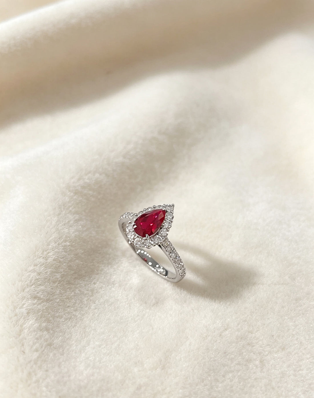 Halo setting pear cut lab grown ruby engagement ring