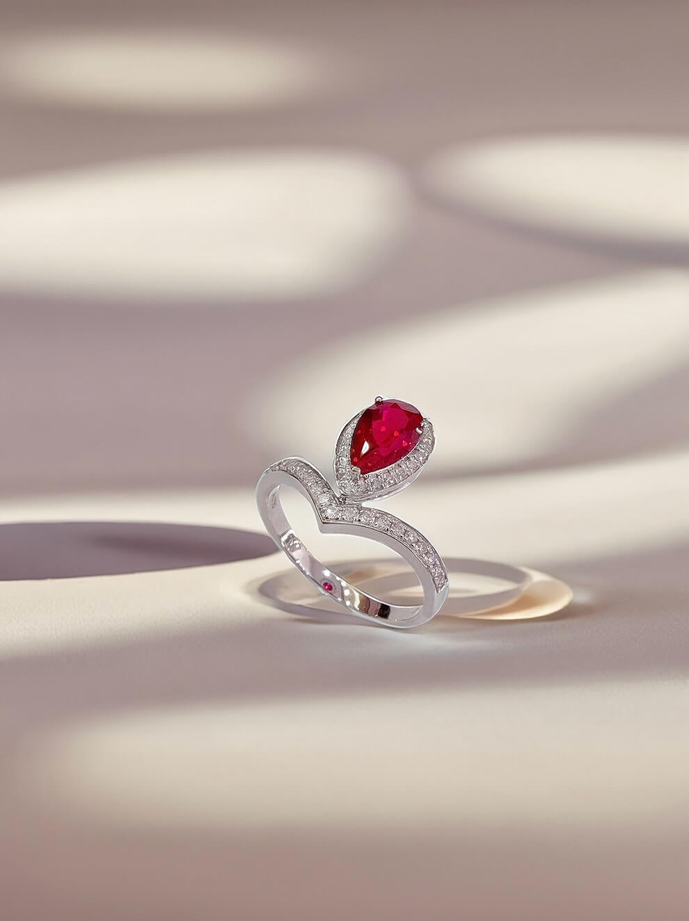 Halo setting pear cut lab grown ruby engagement ring