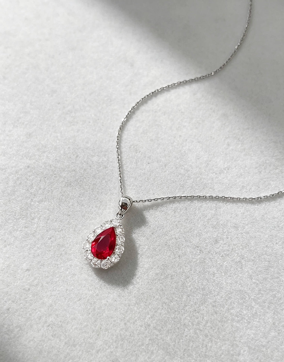Halo setting pear cut lab grown ruby pendant necklace